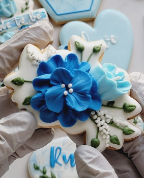 Beautiful blue flower royal icing decorated cookie