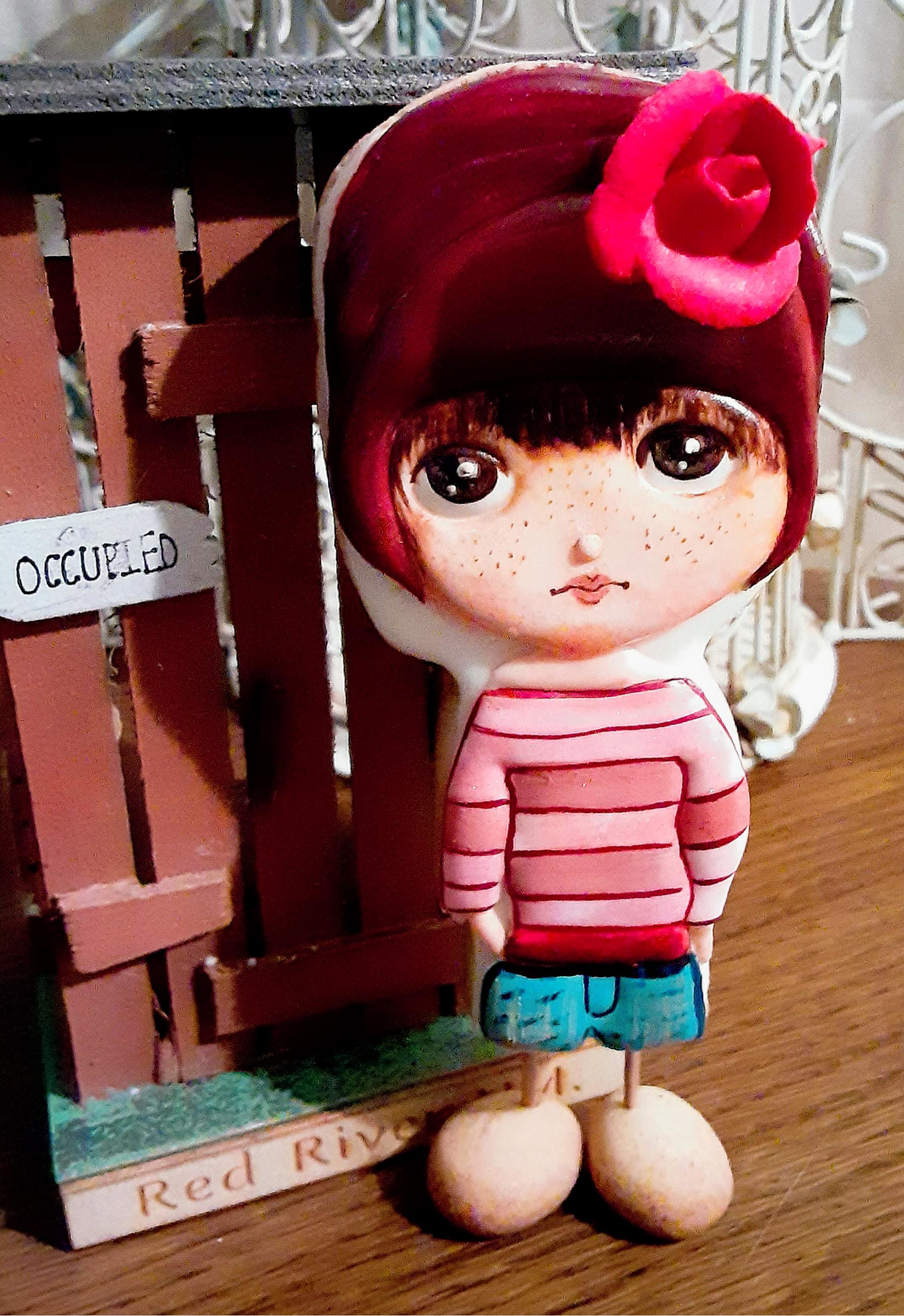 Hand painted royal icing doll cookie with a pink 3D rose